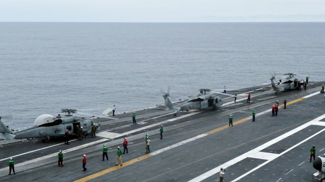 DISPUTED WATERS. This photograph taken on October 24, 2013 in the South China Sea shows US navy helicopters on the USS George Washington aircraft carrier. Martin Abbugao/AFP