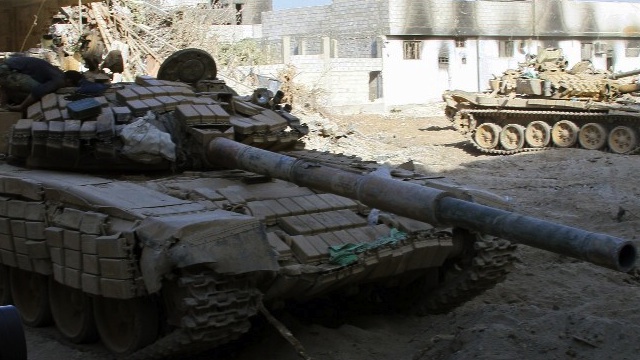 WARFARE. Syrian army tanks are seen deployed in the Jobar neighborhood of Damascus on August 24, 2013. AFP/Stringer