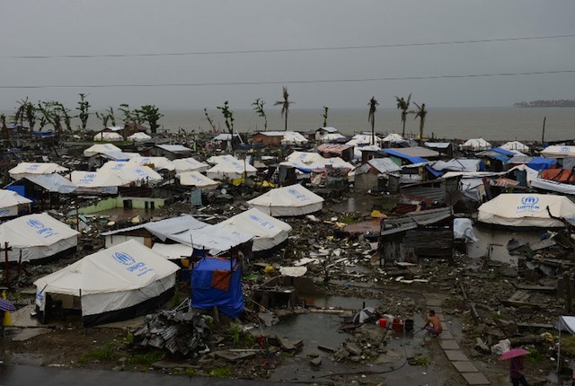 IN THE RAIN. Tents are erected as temporary shelters for residents whose houses were flattened by super Typhoon Haiyan in Tacloban city, Leyte province, on December 25, 2013. AFP/Ted Aljibe