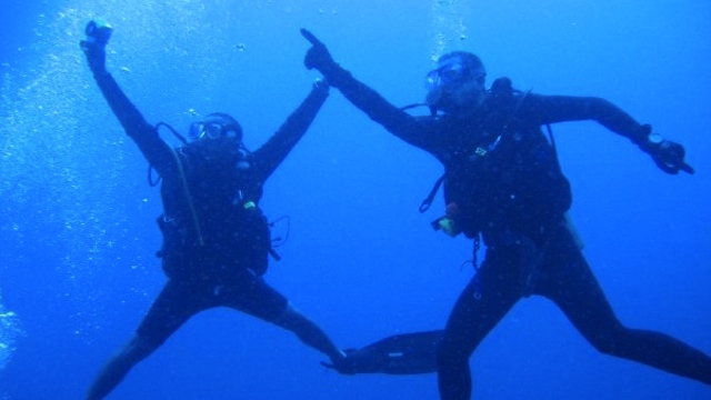 WAITING FOR SHARKS. The author (R) sees what he thought was a manta ray or a hammerhead shark but ended up being a fellow diver