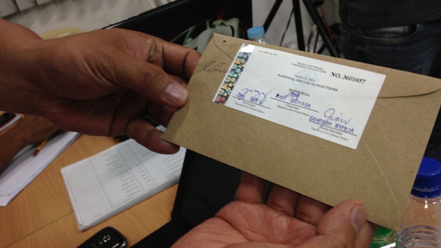 OFFICIAL SEAL. If the results of a CF card do not automatically transmit to the COMELEC, then the card must be enclosed in an envelope with an official seal. Photo by Katherine Visconti.